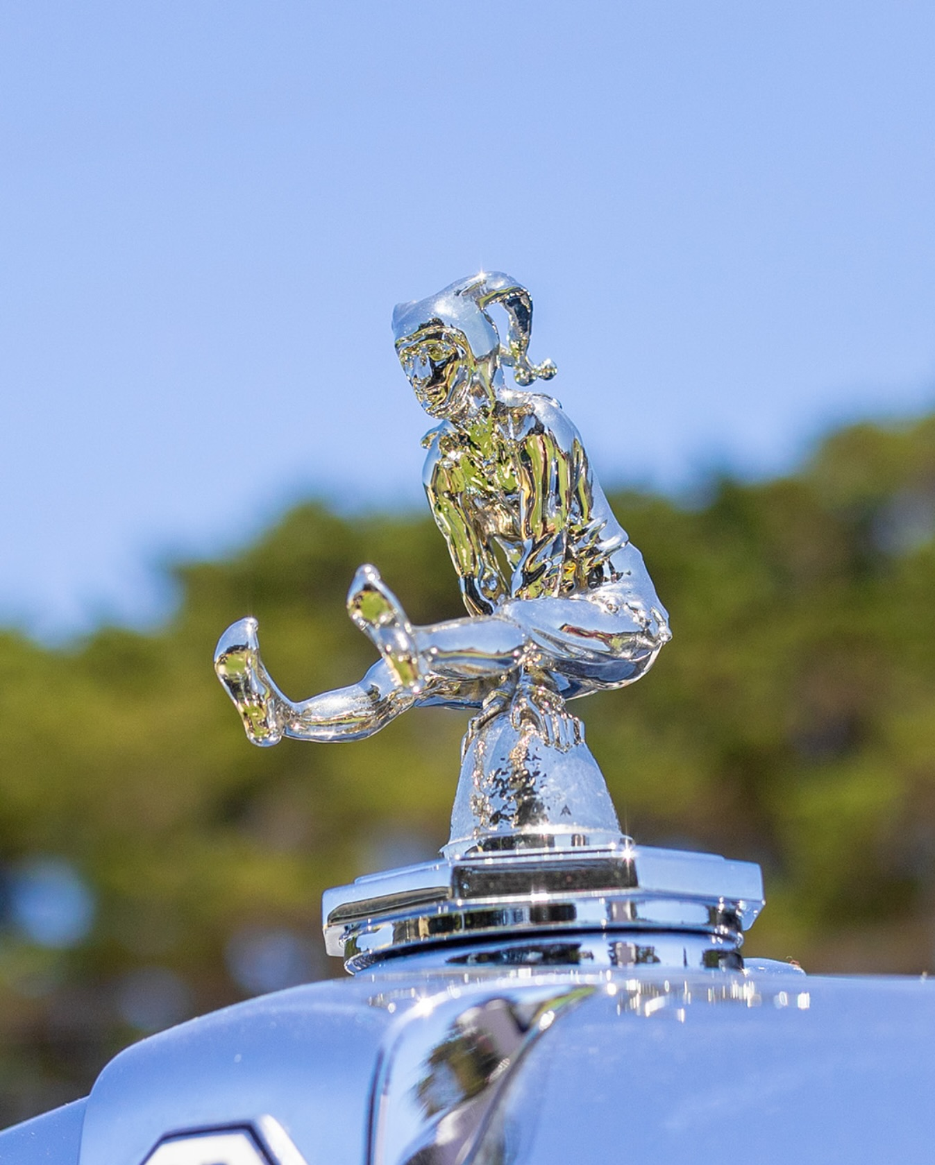 Detail of a Bentley grille with a jester-style hood ornament